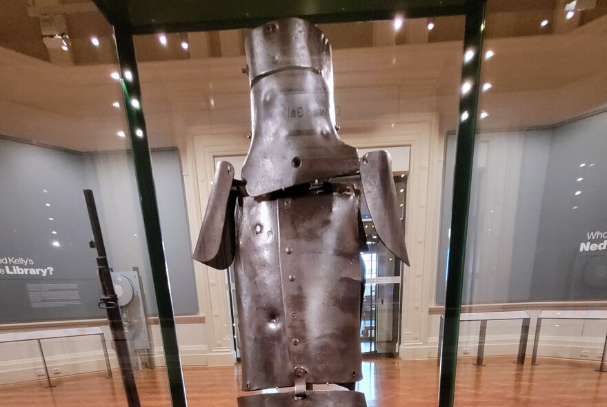 Ned Kelly's suit of armour behind glass inside the State Library of Victoria.