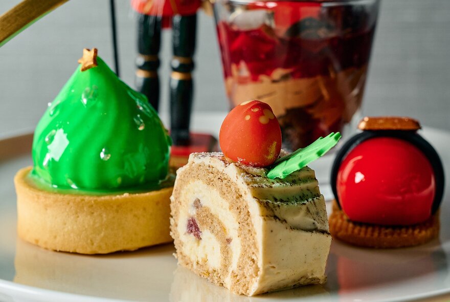 Four different Christmas-themed sweet treats presented as part of a festive High Tea.