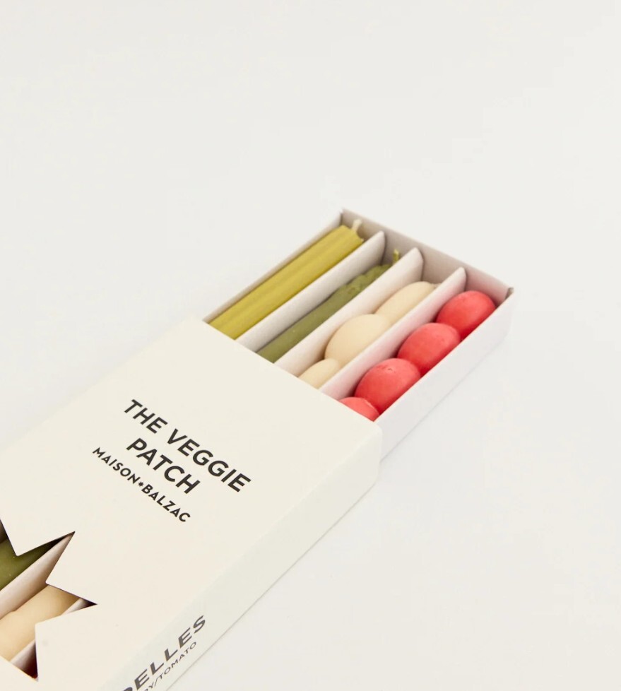 A box of vege-shaped candles in a box with a label saying the veggie patch