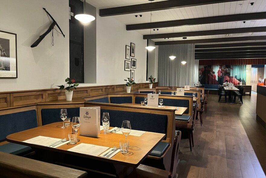 Booth seating in a restaurant with blue bench cushions.