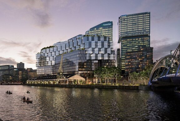A modern, multi-story hotel and residential building complex on the banks of the Yarra River in Melbourne. 