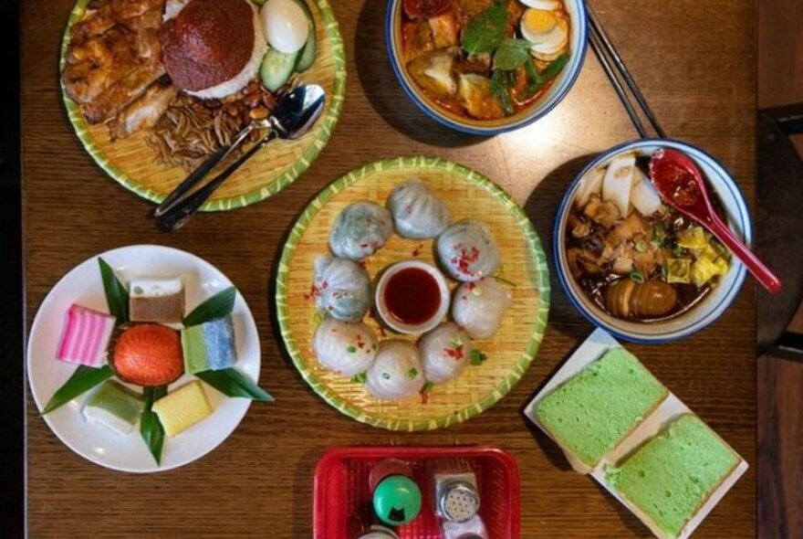 Bowls of dumplings, desserts and soup on a table.