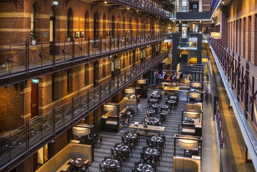 View from mezzanine onto ground-floor restaurant tables.