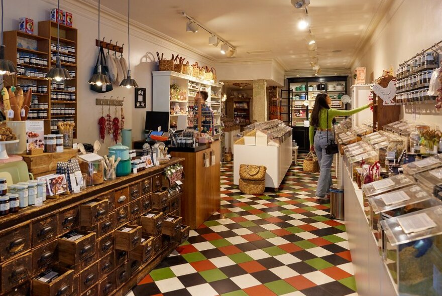 A woman browsing in a spice shop.