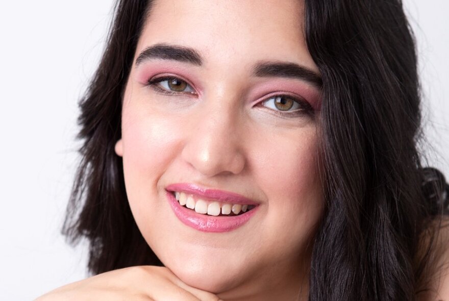 A head shot of classical singer Danielle Zuccala, smiling.