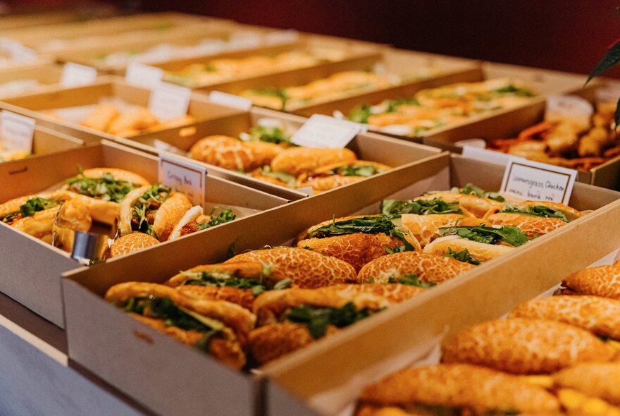 Boxes of banh mi sandwiches.