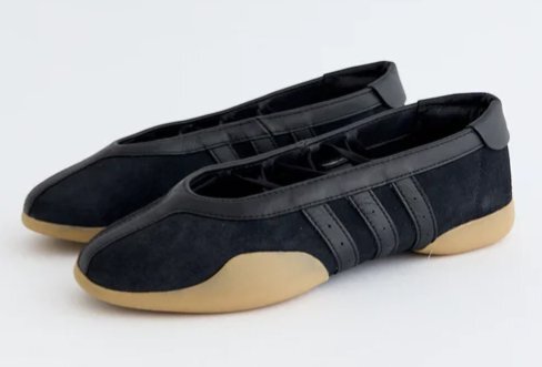 A pair of black ballet flats with Adidas's signature three stripes.