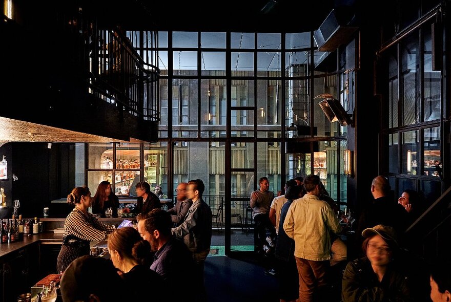 People having drinks inside a dimly-lit bar.