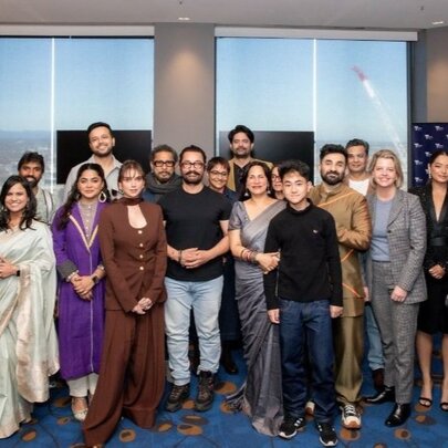 A group of people gathered for a group shot, some in Indian dress. 