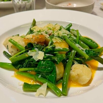 A dish of greens and dumplings.