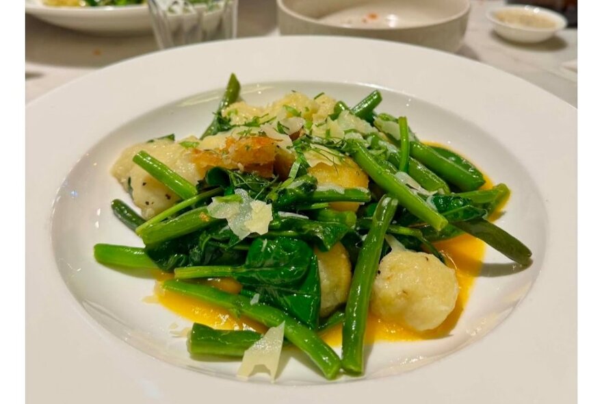 A dish of greens and dumplings.