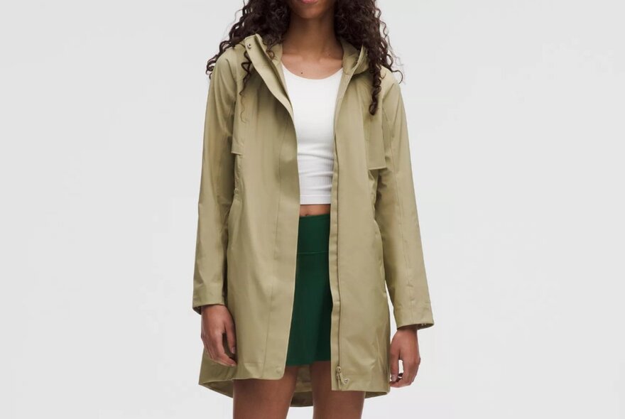 A woman is wearing a beige rain coat