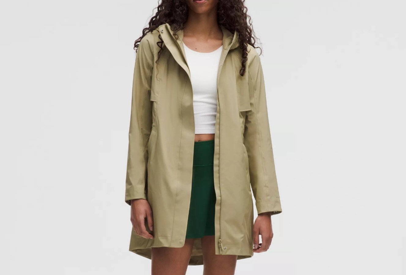 A woman is wearing a beige rain coat