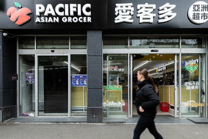 External shopfront with personwalking past.