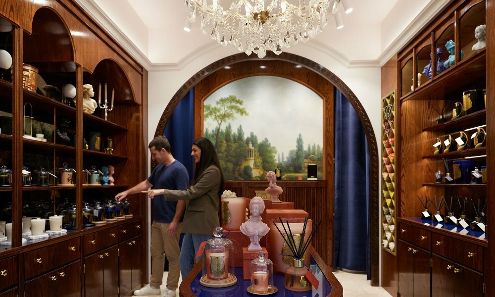 A couple browsing in a luxury candle boutique.
