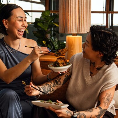 Two individuals enjoying a meal together in a casual setting.