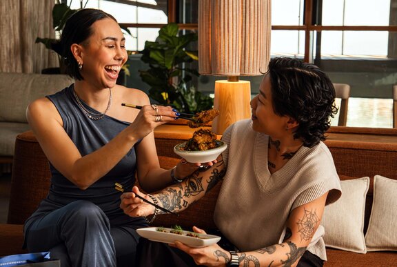 Two individuals enjoying a meal together in a casual setting.