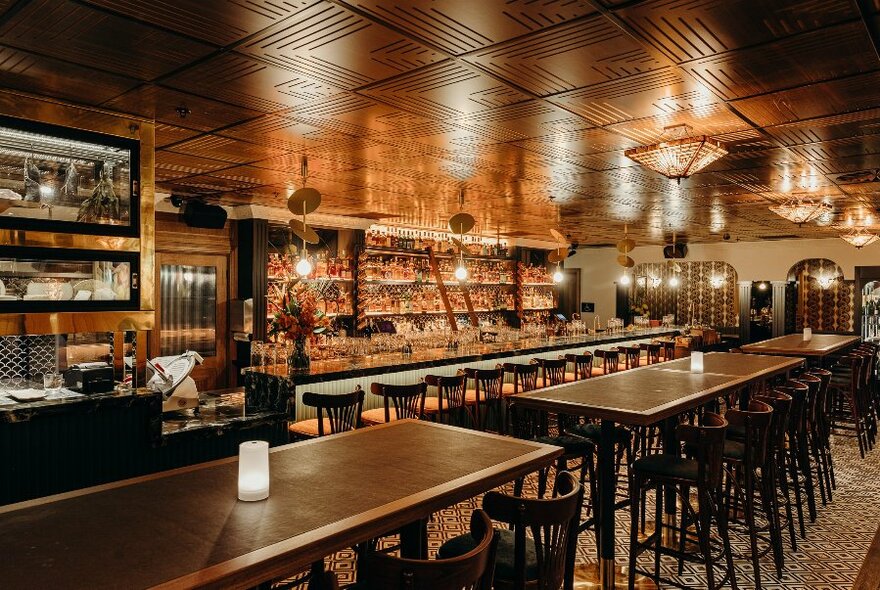 Bar with long restaurant tables.