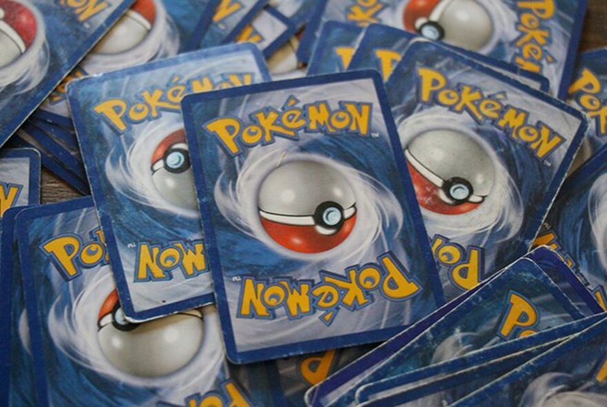 A messy, spread out pile of Pokémon cards.
 