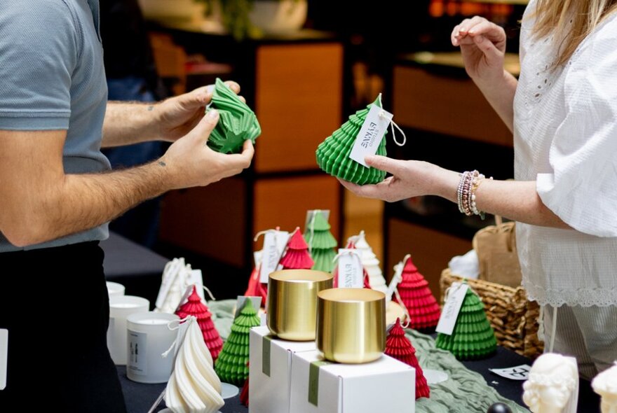 Headless people shopping for candles at a Christmas market