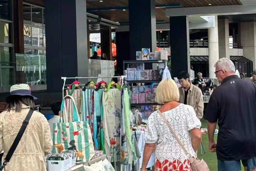 People browsing outside market stalls.
