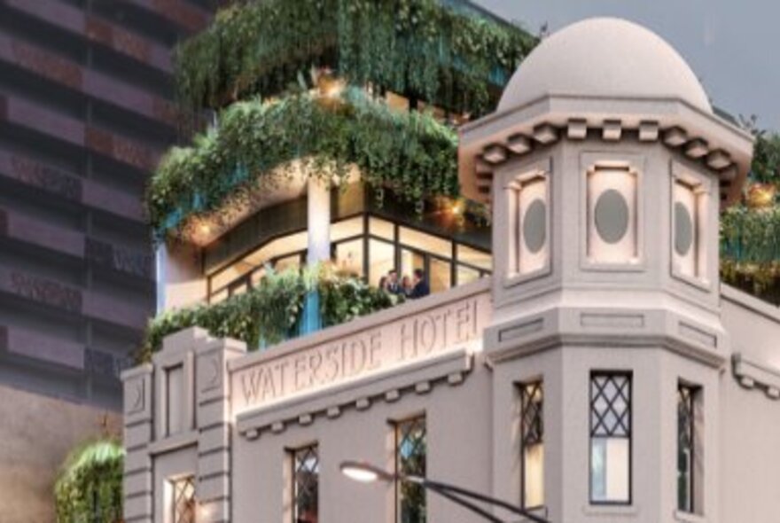 The external facade of the Waterside Hotel, with a vertical garden on the building behind it, seen from the corner.