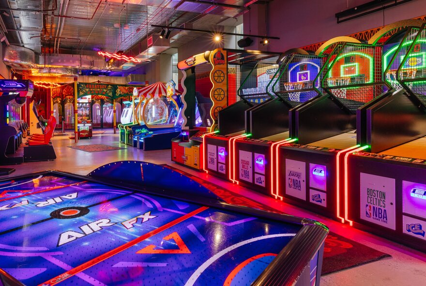 Interior of Archie Brothers games venue with a row of brightly coloured retro arcade games.