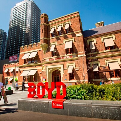 Boyd Community Hub sign outside Southbank Library, a heritage-listed old red brick building.