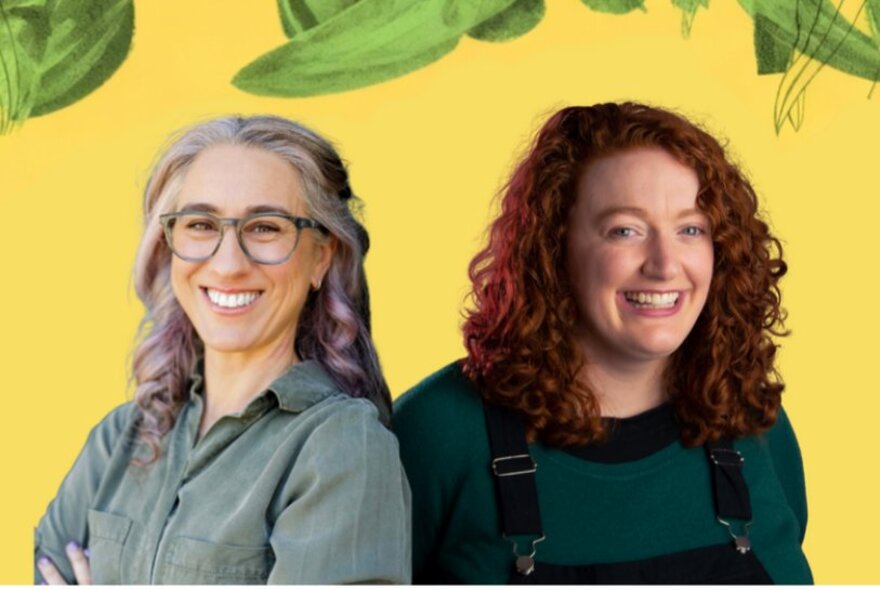 Two women laughing against a yellow background with painted green foliage.