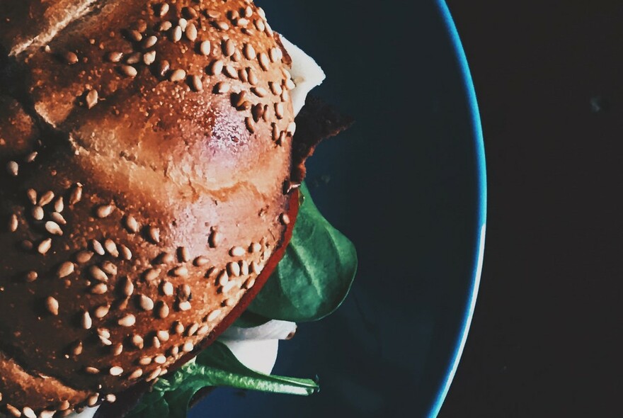 Close-up of a burger bun with sesame seeds.