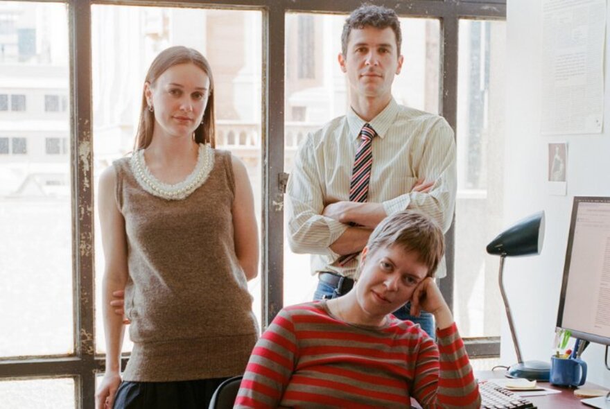 Portrait of Cameron Hurst, Sally Olds and Oscar Schwartz, founders of The Paris End newsletter, in an office setting in front of a window.