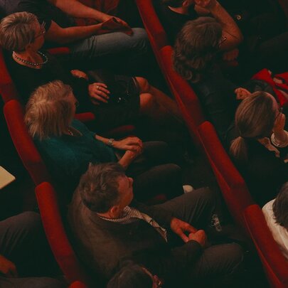 A seated audience in an auditorium, seen from above.