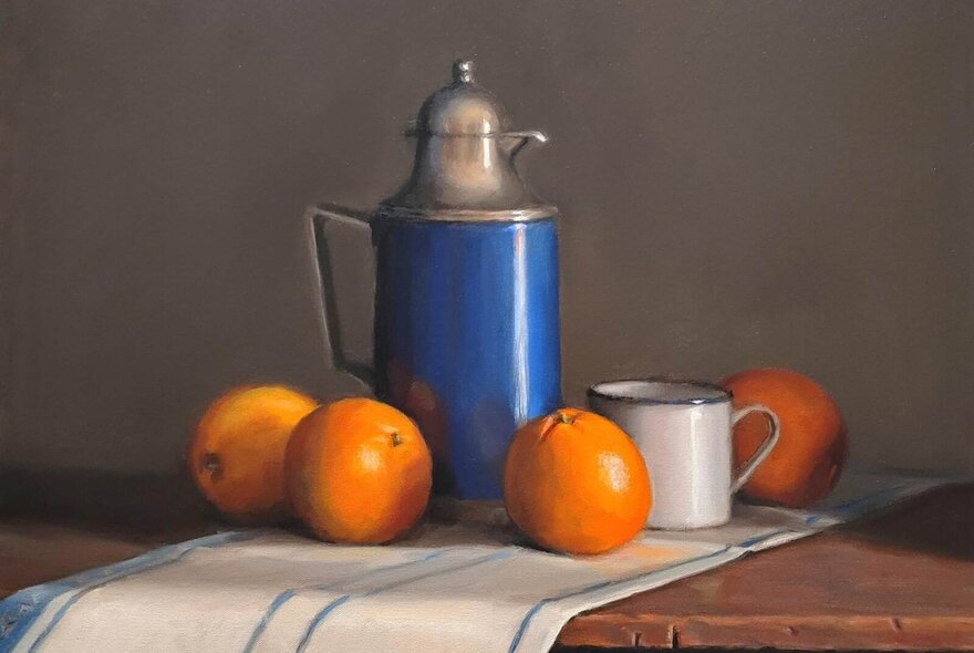 Still life painting of oranges, jub and mug on a tea towel.