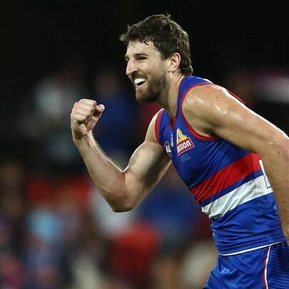 A Western Bulldogs AFL player looking pleased, with his fist clenched in front of his chest. 
