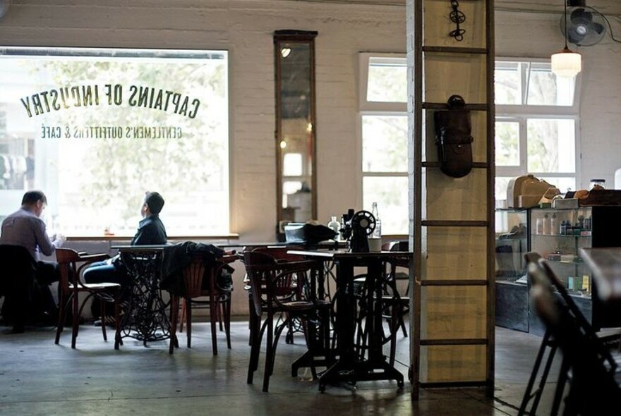 People seated at a table by a large window.