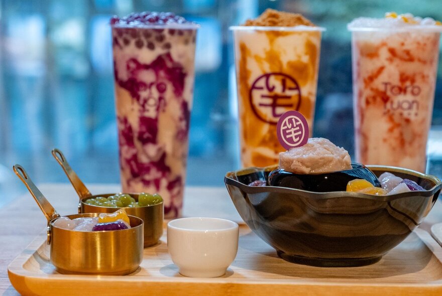 A tray of Taiwanese taro dessert and three tall drinks of differing flavours.