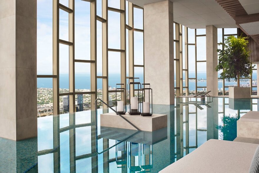 Indoor pool at the Ritz-Carlton, Melbourne, looking through geometric shaped windows to the city below. 