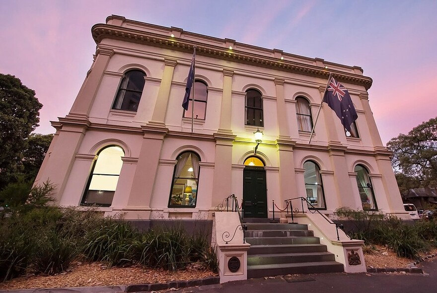 Façade of the Royal Society of Victoria building against a twilight sky.