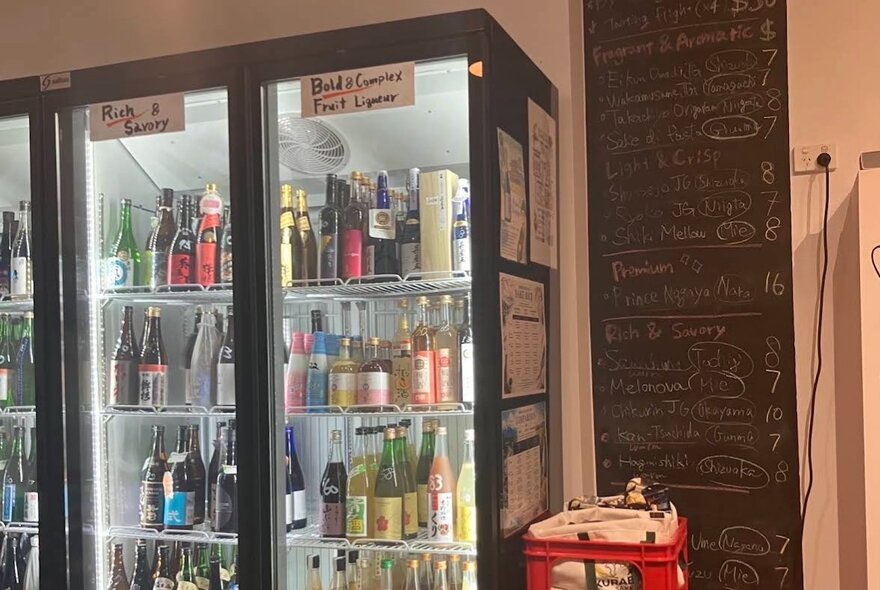 Fridges full of bottles in a bottle shop.