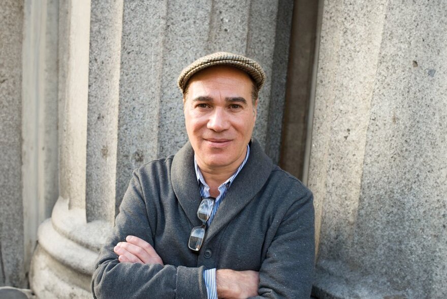 Author, illustrator and environmentalist Yuval Zommer wearing a flat cap with arms crossed.