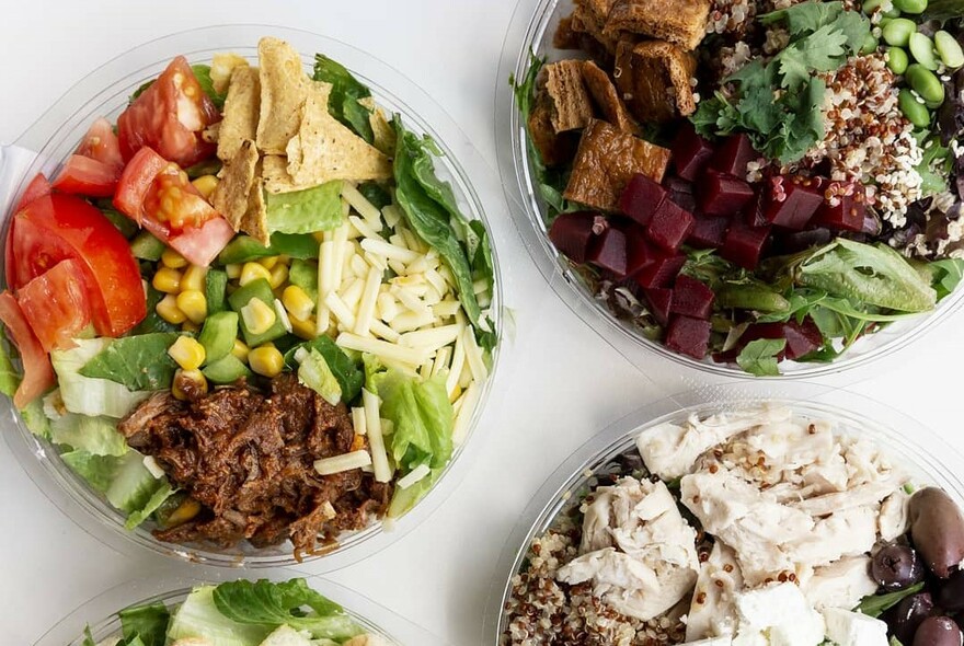 Bird's-eye view of several salad bowls.