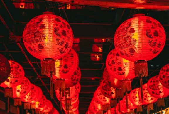 Hanging display of illuminated red Chinese lanterns at night.