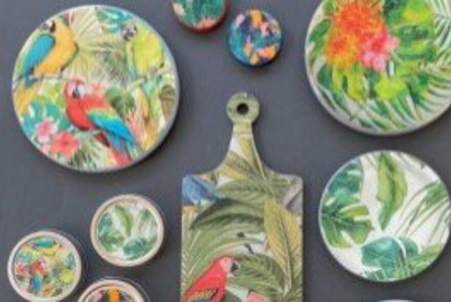 A range of objects on display that have been decorated using the decoupage method of applying layers of paper or fabric and gluing this down.