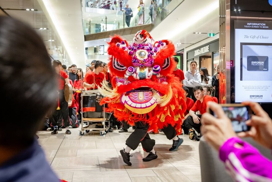 A lion dance taking place inside Emporium Melbourne shopping centre, to celebrate the lunar new year.