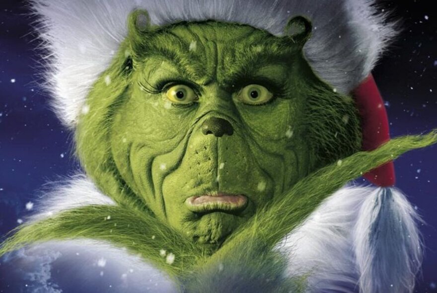 A still of the green grinch from the movie Dr Suess’ How the Grinch Stole Christmas.