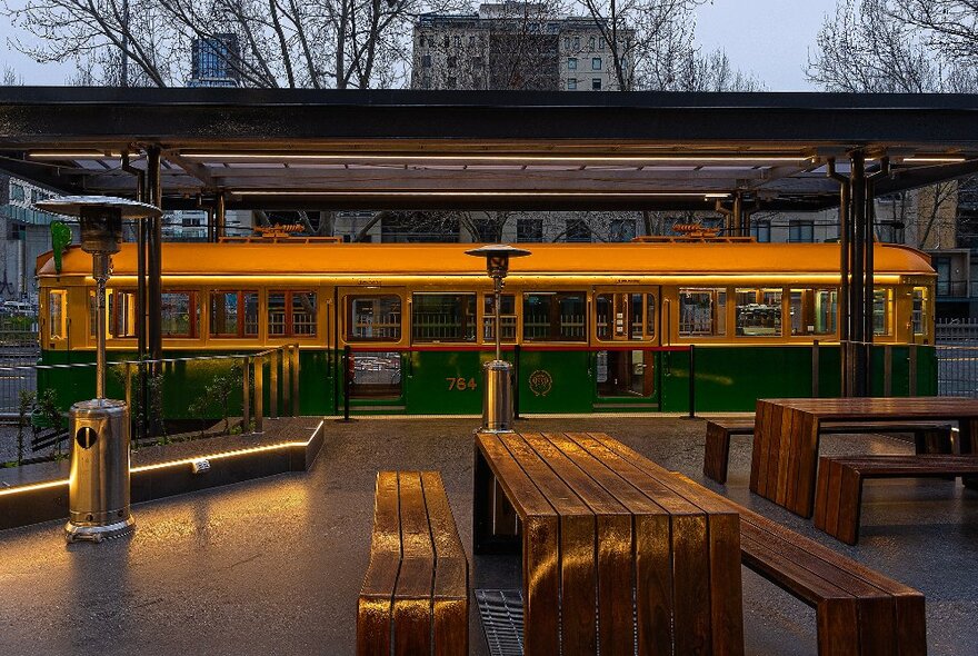 The heritage Melbourne Tram cafe, parked in an outdoor cafe setting with seating and shelter.