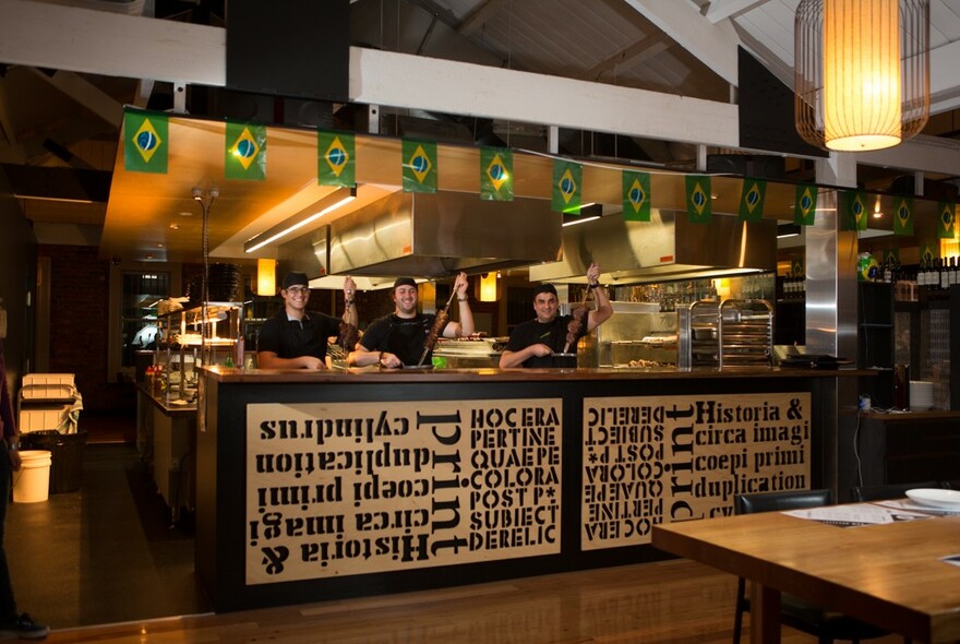 Staff behind the central counter with signage and pendant lighting.