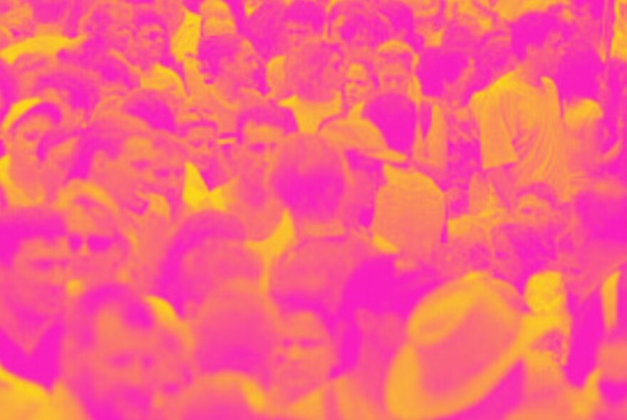 Hot pink and yellow image of a massed crowd of people.