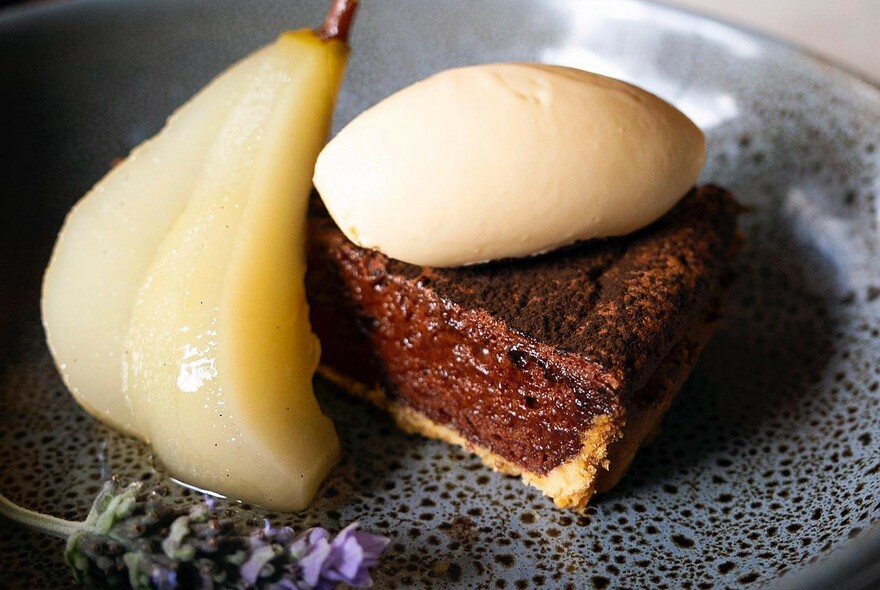 Dessert of pear, cream and chocolate cake.