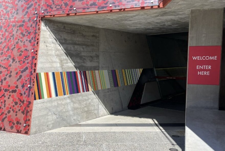 Striped colours, representing Australian military medal ribbons, along the concrete wall at the entrance to the Shrine of Remembrance.